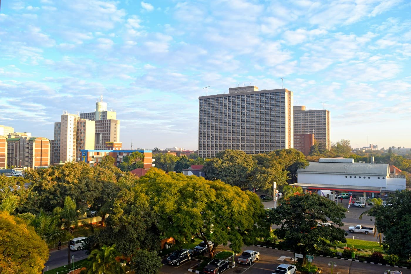 Harare city centre on a bright morning, with tall buildings above green trees