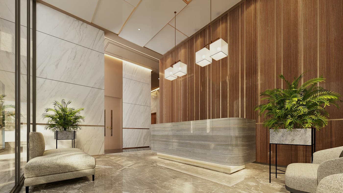 A warm, modern reception with a marble desk, timber wall and pendant lights