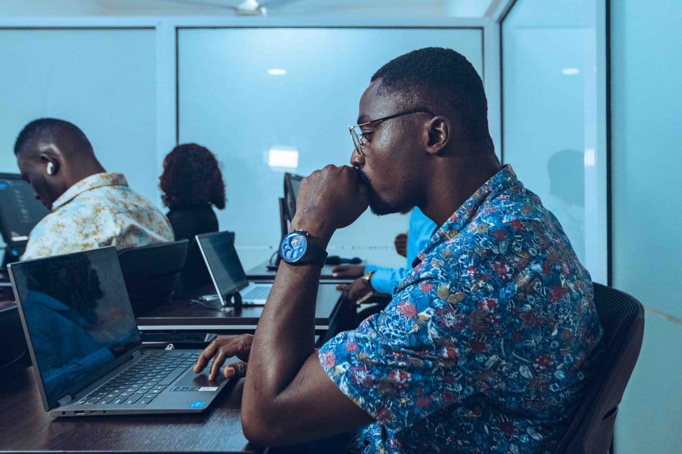 Colleagues working at laptops in a bright office