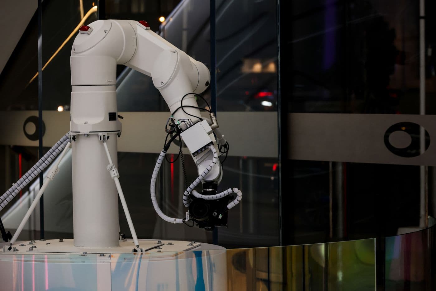 A white robotic arm at work in a modern building